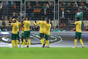 Bafana Bafana's Themba Zwane celebrates one of his goals wirth teammates in the Fifa Series international friendly match against Algeria at Stade Nelson Mandela in Algiers on Tuesday night. 