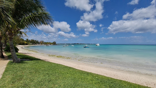 Tropical beach with boats on turquoise sea in this luxury apartment / penthouse for sale in Grand Baie ($3,313,718 - 205 m²)