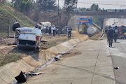 ER24 said a chemical truck was lying on its side and two light motor vehicles were a short distance away, one alight and the other on its roof.