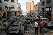 Palestinians inspect damages in the aftermath of Israeli strikes, following a Hamas surprise attack, at Beach refugee camp, in Gaza City, October 9, 2023. 