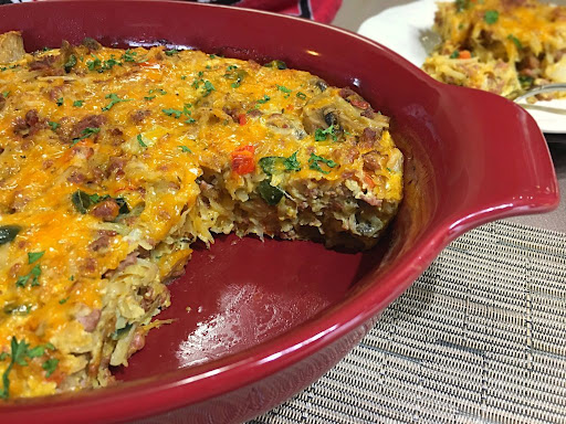 A delicious breakfast casserole with shredded potatoes,veggies and hot Italian sausage