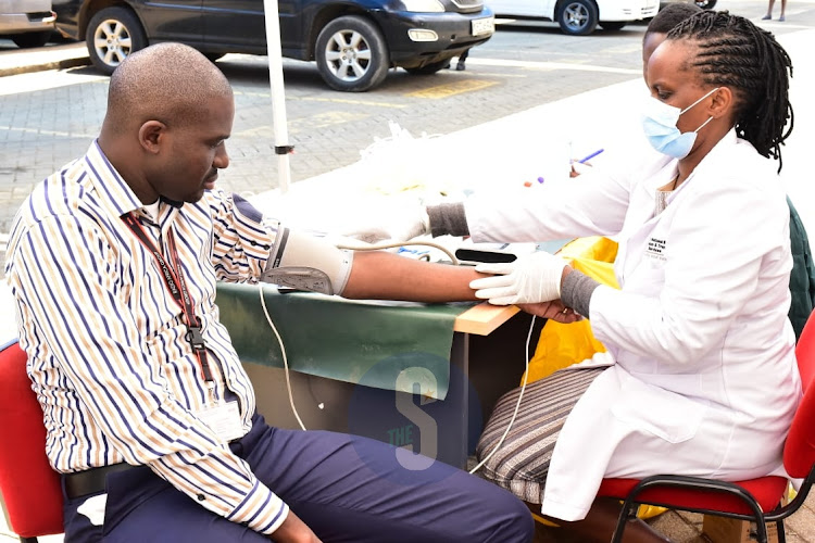 Radio Africa Group Head of Business John Gachahi donates blood during the blood donation drive by Kenya Tissue and Transplant Authority at Radio Africa on November 9, 2022.