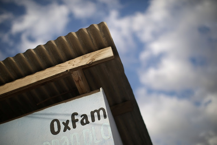 An Oxfam sign above a kiosk in Port-au-Prince, Haiti.