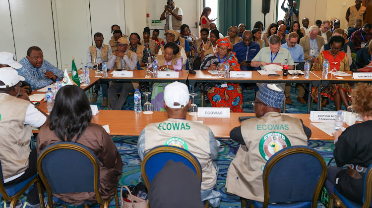 Former President Uhuru Kenyatta with former Sierra Leone President Bai Koroma and during a meeting with Nigeria election observers in Abuja on February 26,2023.