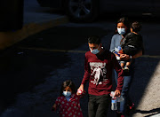 Central American migrants, who were airlifted from Brownsville to El Paso, Texas, US, and expelled from the United States under Title 42, enter the National Institute of Migration (INM), in Ciudad Juarez, Mexico August 25, 2021. 