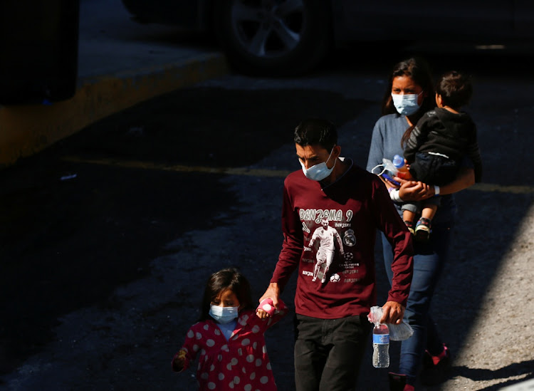 Central American migrants, who were airlifted from Brownsville to El Paso, Texas, US, and expelled from the United States under Title 42, enter the National Institute of Migration (INM), in Ciudad Juarez, Mexico August 25, 2021.