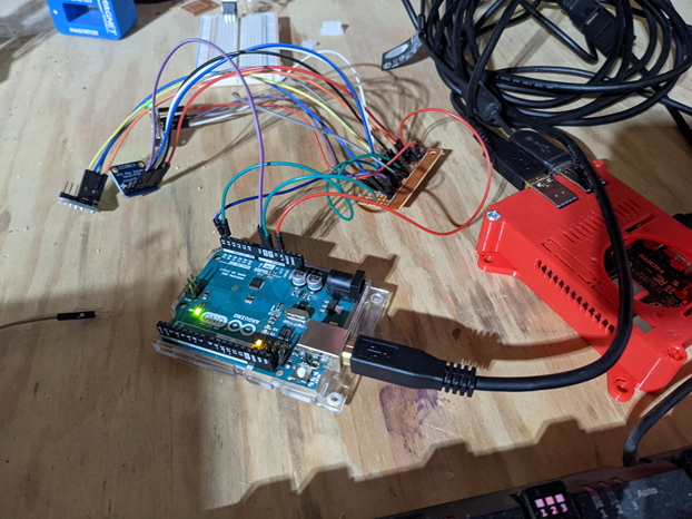 Photo of a functioning Arduino with 3 sensors, sitting on a workbench.