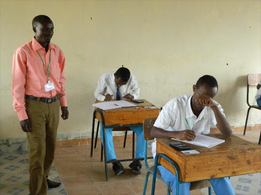 Candidates sit KCSE exam.