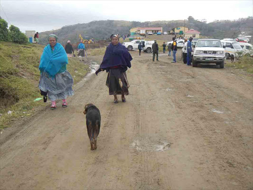 BYE-BYE BUMPS: Nothandekile Somdetsha and Nowinile Piki can’t wait for this stretch between home and the hospital to be tarred Picture: SIKHO NTSHOBANE