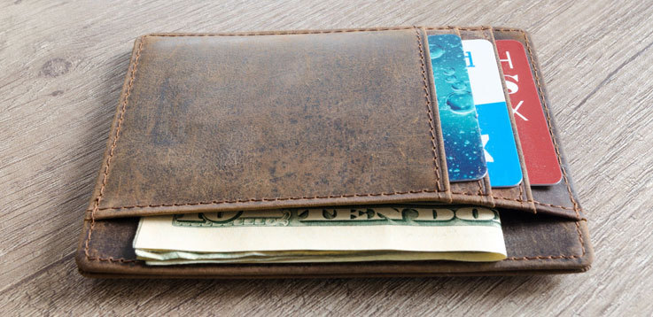 A wallet with cards and dollars