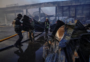 Rescuers and service members work at a site of a shopping mall hit by a Russian missile strike, as Russia's attack on Ukraine continues, in Kremenchuk, in Poltava region, Ukraine June 27, 2022.  