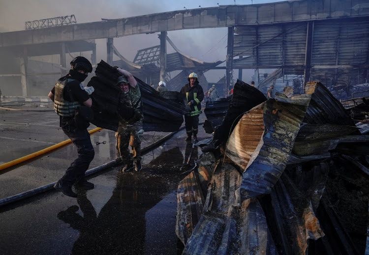 Rescuers and service members work at a site of a shopping mall hit by a Russian missile strike, as Russia's attack on Ukraine continues, in Kremenchuk, in Poltava region, Ukraine June 27, 2022.