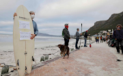 Tired of the stage 4 regulations, surfers protested at a Muizenberg beach.