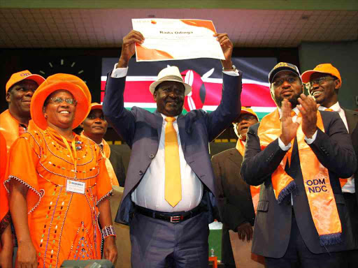 NASA coalition flag bearer Raila Odinga displays his party nomination certificate after he was endorsed as the ODM presidential candidate during the National Delegates Conference at Kasarani on May 5 last year. /JACK OWUOR