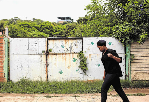 HANDS OFF: The gate to the property in Pretoria that once belonged to paedophile and suspected serial killer Gert van Rooyen. Neighbours say it has become a run-down eyesore and developers are put off by its history