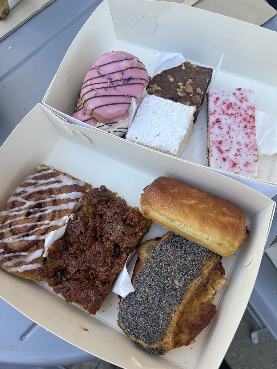 Top box: strawberry eclair, brownie, coffee flavored puff pastry, raspberry shortbread. 
Bottom box: cinnamon roll, brown sugar coffee cake, chocolate crescent, almond pastry.