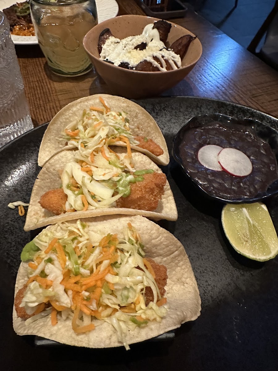 Pescado tacos with black beans and fried plantains