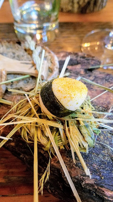 Fimbul Icelandic Dinner Spring 2018, Snacks Course of A board of Cod Cheek with fermented barley, dill mayo and mustard flowers; Pickled quail egg with smoked vinaigrette and ash roe dust; Dung smoked trout (using local dung from Sauvie Island and hay) with honey roasted radish, hay honey butter; Dulse bread