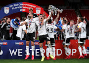 Tom Cairney and Aleksandar Mitrovic celebrate after winning promotion back to the Premier League.