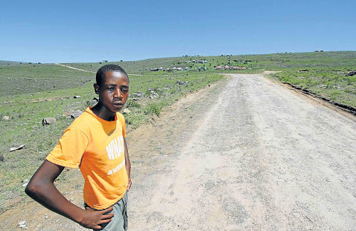 ESCAPED: Sifiso Maphoyi, 16, at the spot where five of his friends were struck by lightning at Matolweni village near Mthatha on Thursday when he stayed at school to wait for a friend who had his books Picture: LULAMILE FENI