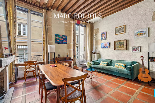 Property purchase in Paris 6ème (75006) - Dining and living room with green sofa