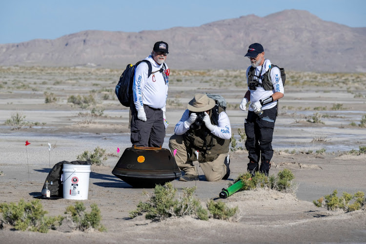 The return capsule containing a sample collected from the asteroid Bennu in October 2020 by Nasa’s OSIRIS-REx spacecraft is seen shortly after touching down in the desert at the department of defense’s Utah Test and Training Range in Dugway, Utah, US on Saturday. Picture: NASA/KEEGAN BARBER/HANDOUT VIA REUTERS