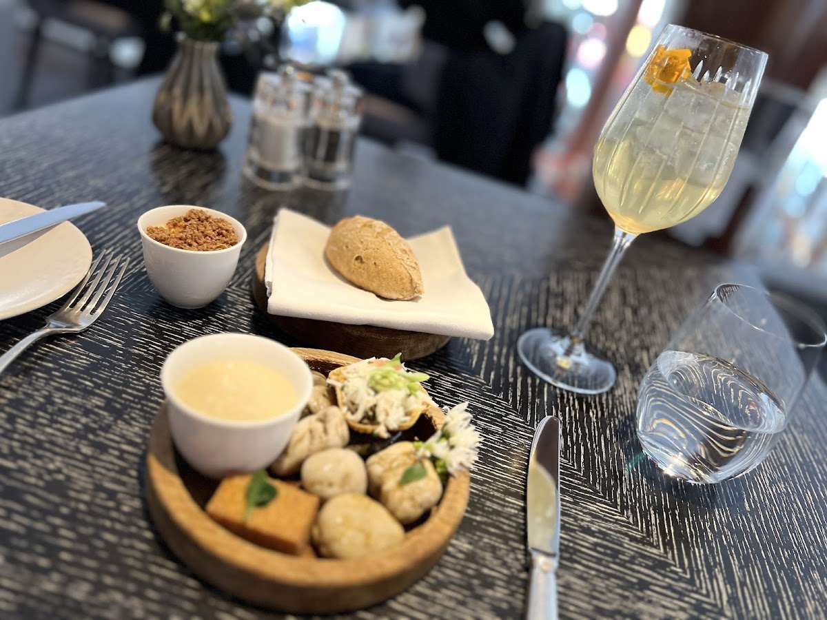 Canapés and fresh bread with an onion spread with bacon crumbs