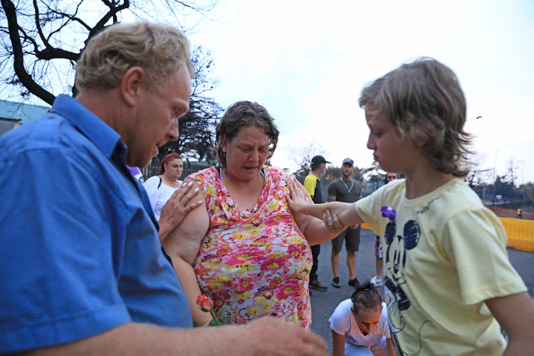 Families and friends pray during the memorial service.