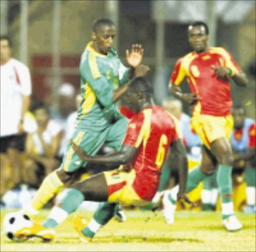 MY BALL: Bafana Bafana striker Sibusiso Zuma is blocked by Guinea's Camara Ababacar in their international friendly match at Super Stadium in Pretoria yesterday. Pic. Antonio Muchave. 09/09/2008. © Sowetan.