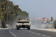Israeli tanks drive on a road following a mass infiltration by Hamas gunmen from the Gaza Strip,  near Sderot in southern Israel October 8, 2023. 
