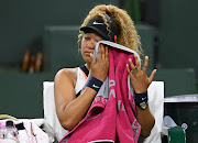 Naomi Osaka (JPN) wipes her face as she talks to referee Claire Wood after a spectator disrupted play, yelling “Naomi you suck,” before the start of her 2nd round match against Veronika Kudermetova (RUS) at the BNP Paribas open at the Indian Wells Tennis Garden. 