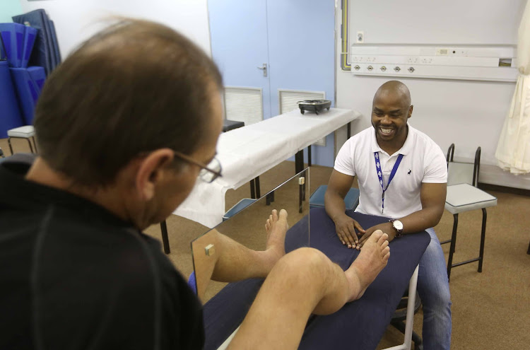 Pain researcher and physiotherapist, Maxwell Katleho Limakatso, with Nico Oosthuizen - who suffers from phantom limb pain.