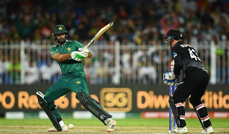 Imad Wasim of Pakistan plays a shot as Tim Seifert of New Zealand looks on during the ICC Men's T20 World Cup match between Pakistan and New Zealand at Sharjah Cricket Stadium on October 26, 2021 in Sharjah, United Arab Emirates.