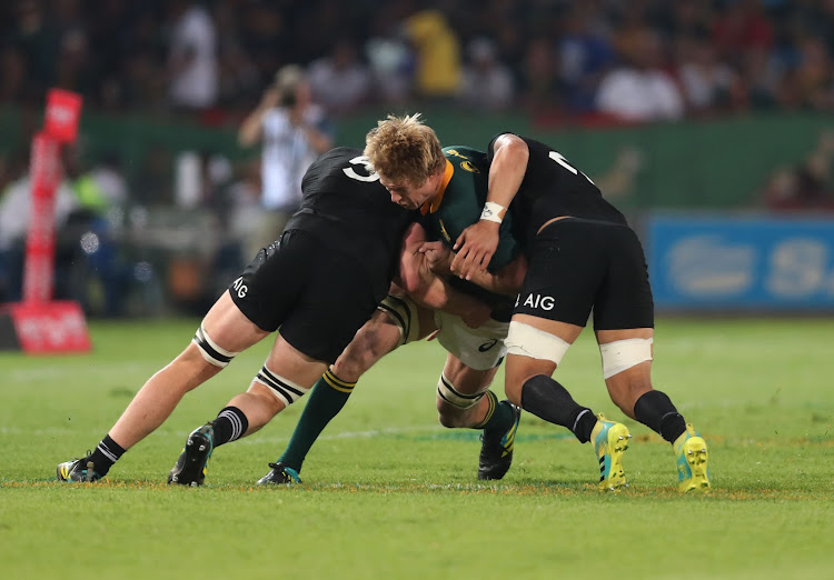 Pieter-Steph du Toit of South Africa powers into a tackle from Ardie Savea and Scott Barrett of New Zealand during the 2018 Rugby Championship match at Loftus in Pretoria.