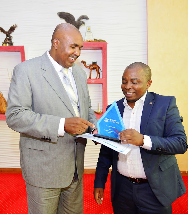 Mount Kenya University founder and chairman Simon Gicharu and researcher Donatus Njoroge