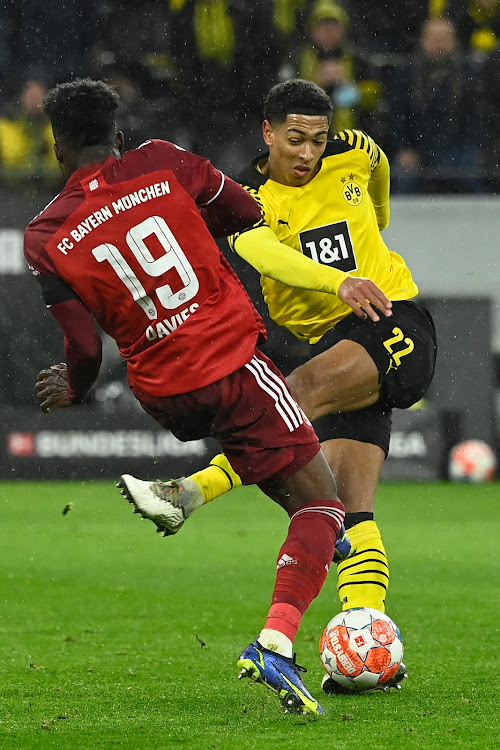 Dortmund midfielder Jude Bellinghamin action with Bayern Munich's Alphonso Davies on December 4