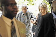 'FIRST LADY': Former president Nelson Mandela is helped by his personal assistant, Zelda la Grange, at the Saxon Hotel in Johannesburg in 2007