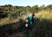 The water 80-year-old Mpiyesende Ngcobo collects from the river behind his homestead is stored in bottles.