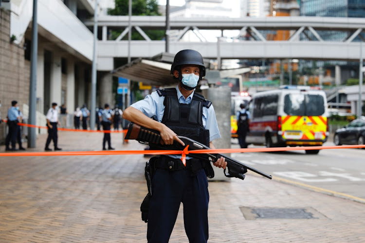 Armed police stand guard as a prison van carrying activist Andy Li arrives at the high court in Hong Kong on August 19 2021. Picture: REUTERS/TYRONE SIU