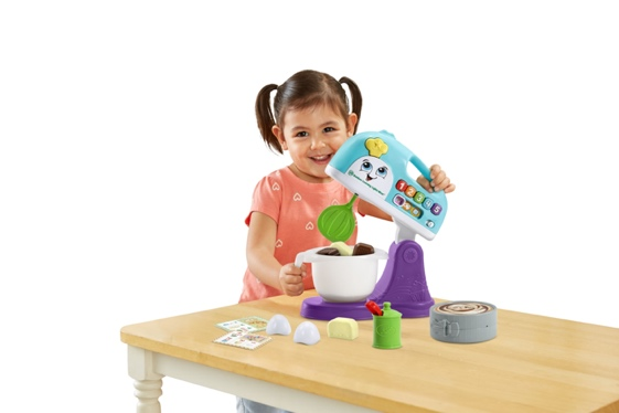 A young child playing with a toy mixer

Description automatically generated