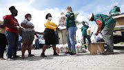 Flood victims from Thembalethu receive food parcels from the Gift of the Givers.