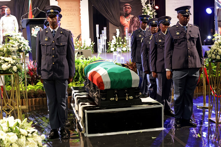 Police officers stand next to the coffin of playwright Mbongeni Ngema during his special provincial funeral at the Durban International Convention Centre on Friday.