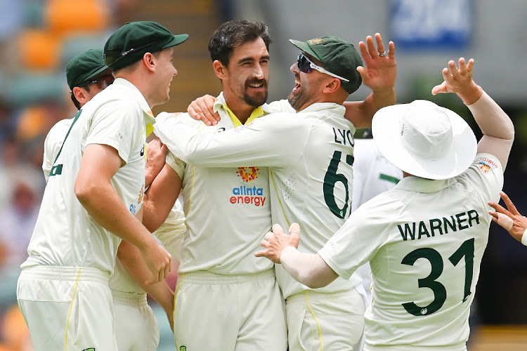 Mitchell Starc of Australia is congratulated after dismissing Rassie van der Dussen of South Africa and getting his 300th Test wicket on day two of the first Test at The Gabba in Brisbane on December 18 2022.