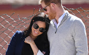 Meghan, Duchess of Sussex, snuggles up to Prince Harry during a visit to a local secondary school in Asni during their royal tour of Morocco.