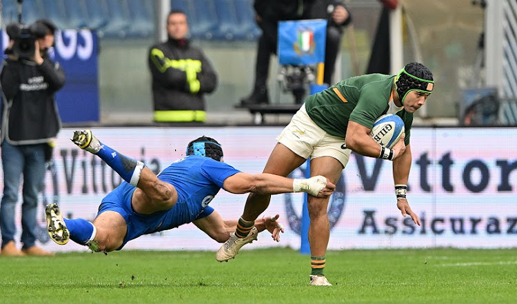 The Springboks' Cheslin Kolbe is challenged by Juan Ignacio Brex of Italy in the Test at Stadio Luigi Ferraris in Genoa on November 19 2022. Kolbe will miss the next Test against England at Twickenham.