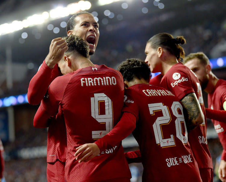 Liverpool players celebrate during their Champions League match against Rangers