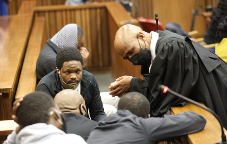 Advocate Malesela Teffo consults his clients during court proceedings in the Senzo Meyiwa trial.