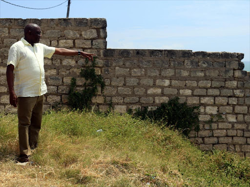 National Land Commission chairman Muhammad Swazuri points at a grabbed piece of public land at Mama Ngina Drive, Mombasa, yesterday /JOHN CHESOLI