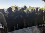 At noon the homeless line up to be served food at Tshwane's Lukas van den Berg sports ground where a temporary camp has been set up for the lockdown.