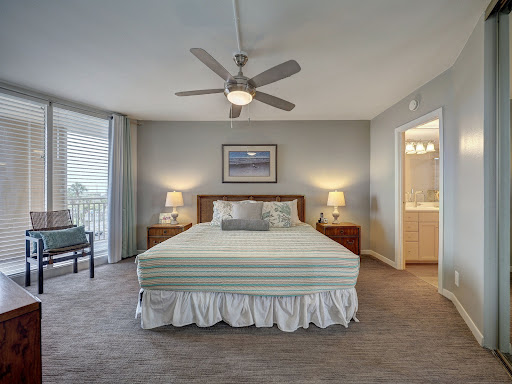 Bedroom with king-size bed and bathroom in this luxury apartment / penthouse for sale in Port Aransas ($645,000)